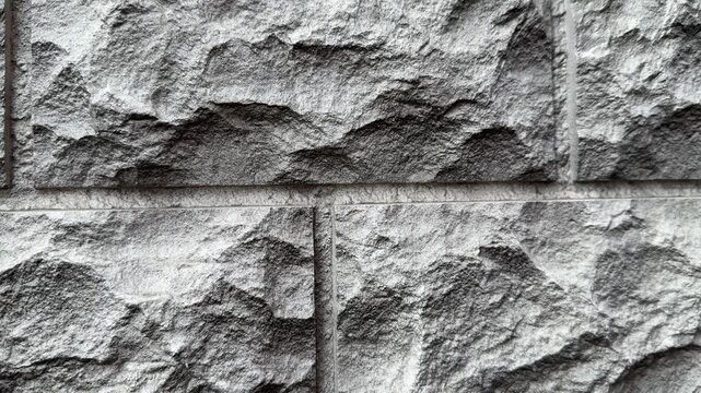Close-up natural quartz facade panels showcasing rugged stone texture and modular layout, detailed grain and chiseled seams