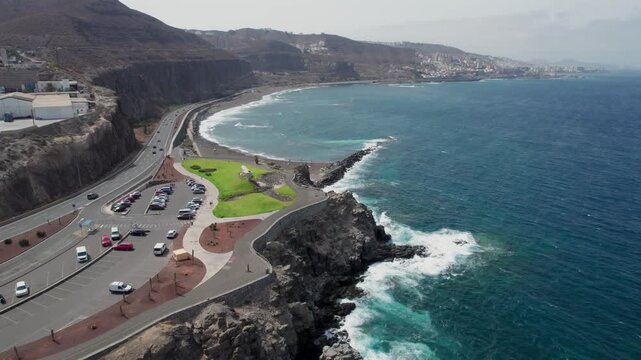 Aerial perspective of La Laja beach and the Atlantic Ocean coastline in Las Palmas de Gran Canaria, showcasing a scenic viewpoint and traffic