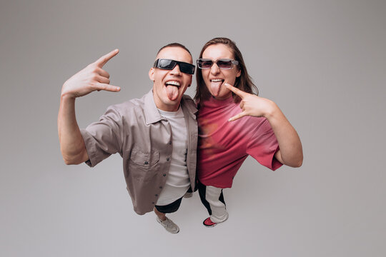 Fun Young Dancers Showing Rock Hand Gesture in Studio