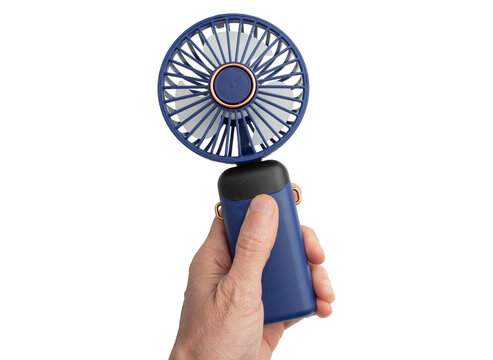 Handheld portable fan held by a hand isolated on a white background