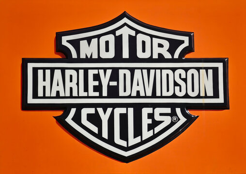 Harley Davidson Motorcyles brand shield emblem on orange background