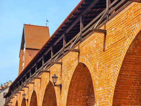 Reconstructed Medieval City Wall Riga &mdash; Red Brick Arches with Wooden Gallery and Ramer Tower in Background