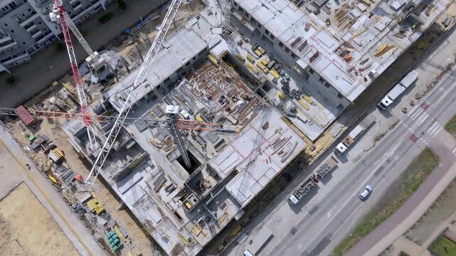 Aerial Top-Down View of a Modern Construction Site with Tower Cranes and Workers, Representing Smart City Development, Urban Infrastructure Growth
