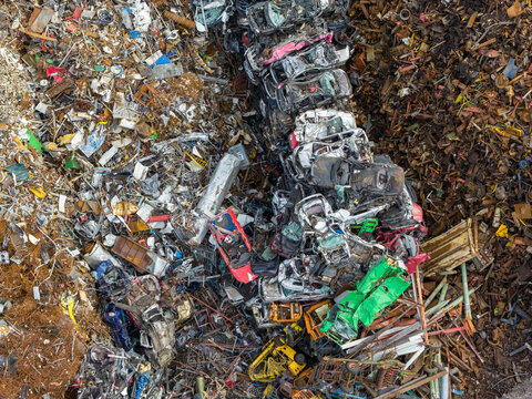 Aerial view of scrapped cars and crushed metal debris piled in a junkyard and recycling site in Hoogeveen, Drenthe, Netherlands.