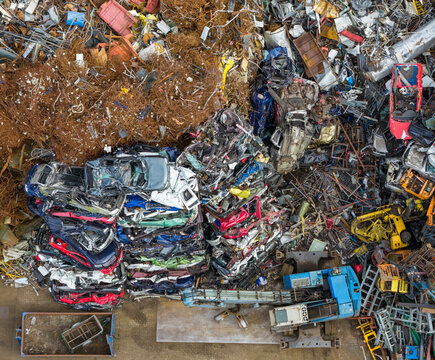 Aerial view of scrapped cars and crushed metal debris piled in a junkyard and recycling site in Hoogeveen, Drenthe, Netherlands.