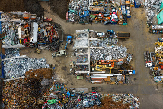 Aerial view of scrapped cars and crushed metal debris piled in a junkyard and recycling site in Hoogeveen, Drenthe, Netherlands.