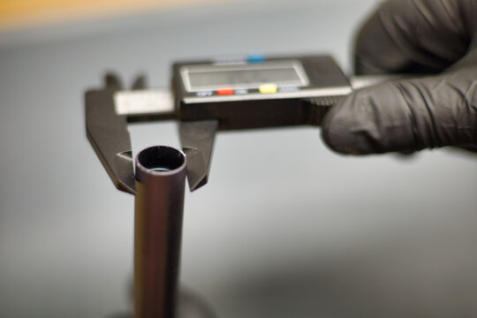 Digital caliper measuring inner diameter of metal tube