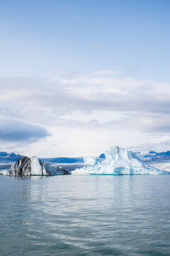 Travel concept. Beautiful landscape with glacier lagoon with view of icebergs floating. Travel landmark,vertical copy space banner