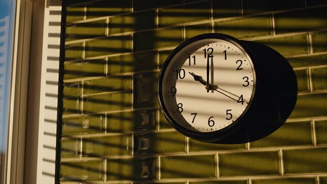 Outdoor clock on a brick wall casting a shadow.