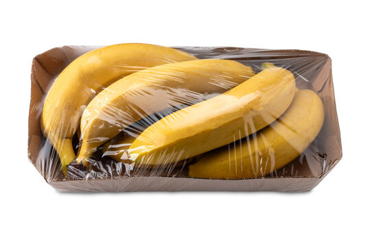 Fresh Cavendish bananas packaged in acardboard tray lined with clear plastic wrap, isolated