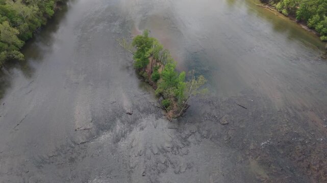 Orbiting footage over slow moving Catawba River and single island