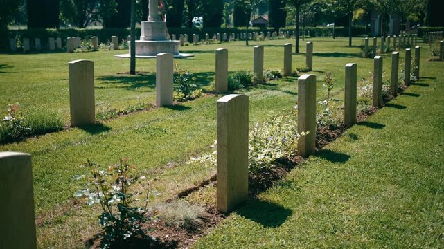 Rows Of Gravestones In Cemetery Lawn