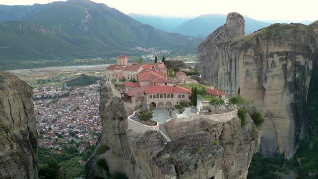 Epic Aerial Monastery of Holy Trinity Sunset Slow Flight Clockwise in Meteora, Greece. Church on Narrow Mountain Rock Incredible Landscape Close