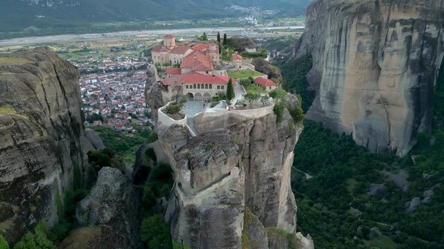 Aerial Monastery of Holy Trinity Sunset Slow Flight Towards Church in Meteora, Greece. Epic on Narrow Mountain Rock Incredible Landscape Close