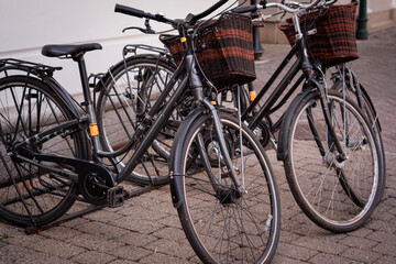 Fototapeta premium City Bicycles with Wicker Baskets Parked on European Street