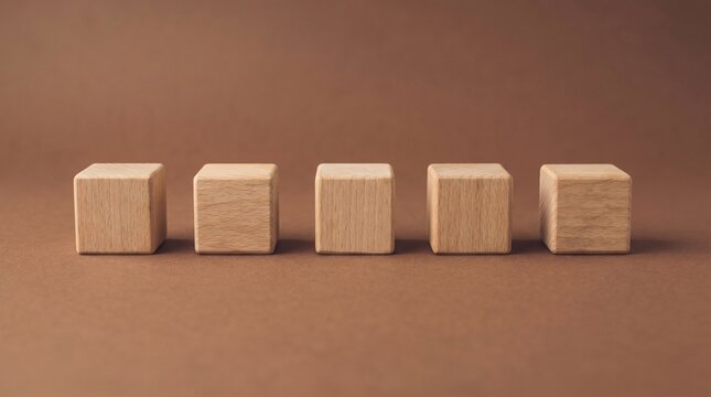 Five wooden blocks neatly arranged in a row against a brown background, symbolizing concepts such as building, construction, and design