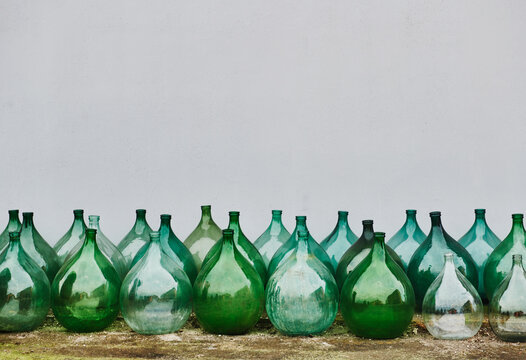Vintage Italian demijohns, large glass bottles typically used for wine making.