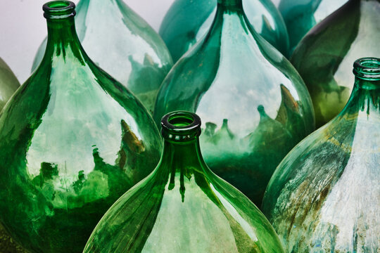 Vintage Italian demijohns, large glass bottles typically used for wine making.