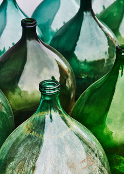 Vintage Italian demijohns, large glass bottles typically used for wine making.