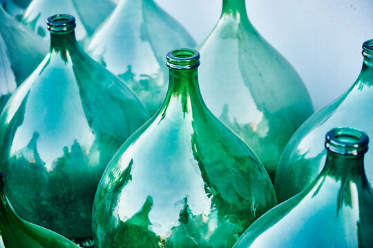 Vintage Italian demijohns, large glass bottles typically used for wine making.