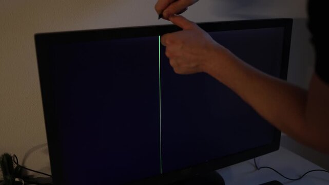 Worker repairing damaged computer display with tools at home office frustrated technology troubleshooting and electronic maintenance cinematic indoor footage