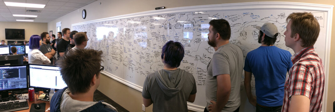 Creative Team Brainstorming Session: Collaborative Whiteboard Ideas and Strategic Innovation in a Multicultural Office Setting