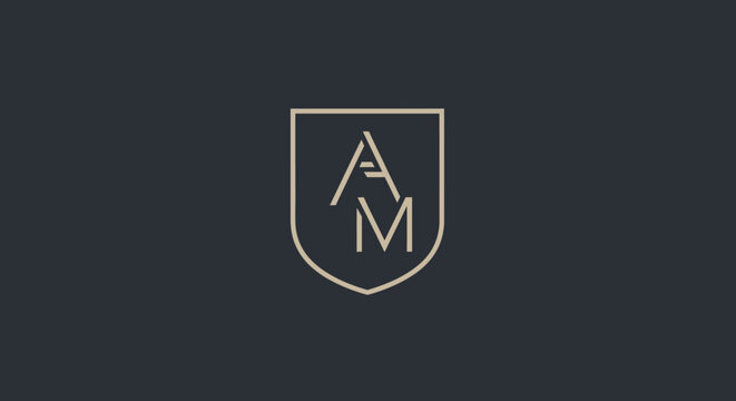 Elegant AM monogram logo with shield on dark background, luxury brand identity