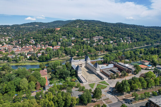 Aerial view of Castello del Valentino with its grand courtyard and historic architecture surrounded by lush parkland and the Po River in Torino, Piemonte, Italy.