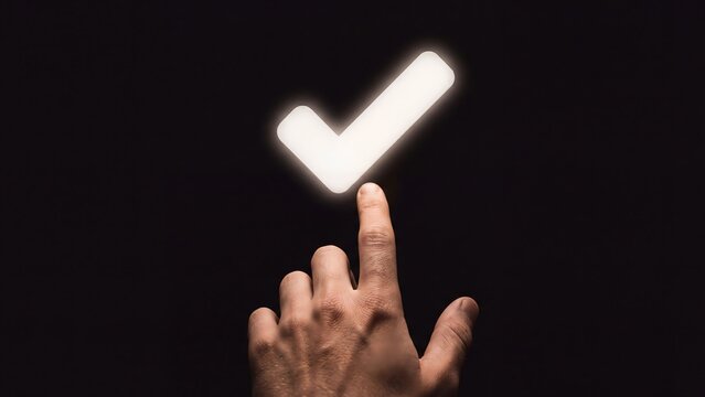 Hand touching a glowing checkmark icon on a dark background, representing decision, completion, or success