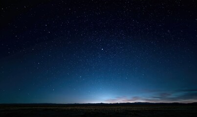 Fototapeta premium Night sky full of stars, horizon glowing blue