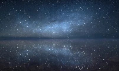 Fototapete Reflection Starry night reflected on still water with Milky Way above  © TheoTheWizard