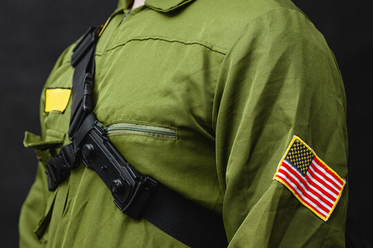Close up of military uniform with American flag patch and tactical bag. Security, law enforcement and tactical service and USA army concept.