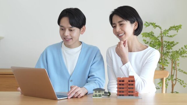 パソコンを見ながら話すカップル