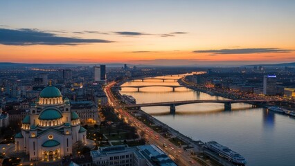 Fototapeta premium Dramatic cityscape featuring St. Sava Temple Belgrade Serbia at sunset with bridges river