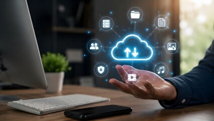Fototapeta premium Hand holding glowing cloud computing hologram with synchronized digital data icons representing secure online file storage and virtual server access