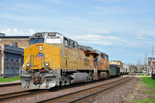 Union Pacific  locomotives double up on the front end to lead a westbound merchadise freight train into the late afternoon sun.