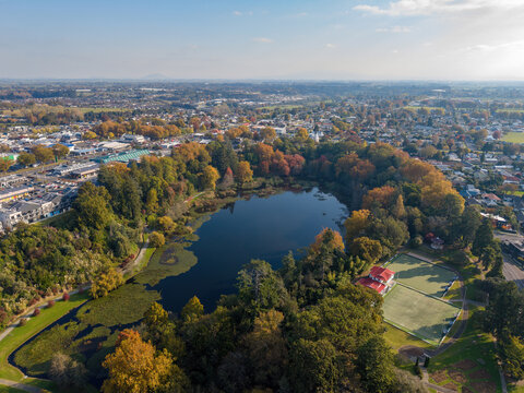 Cambridge, New Zealand, in autumn. Aerial view of Lake Te Koo Utu Reserve, a large park in the middle of town