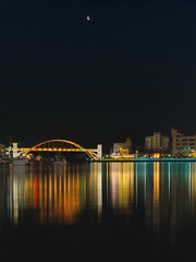 Fototapeta premium Seascape at the illuminated Gangguan Port and Bridge at dark sky night in Tongyeong‑si, Gyeongsangnam‑do, South Korea