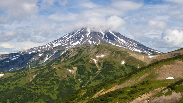 View of the volcano. Travel and tourism on the Kamchatka Peninsula. Beautiful nature of Siberia and the Russian Far East. Vilyuchinsky Volcano (Vilyuchinskaya Sopka), Kamchatka Territory, Russia.