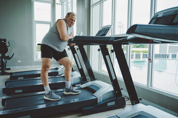Fototapeta premium Senior Man Suffering Chest Pain from Possible Heart Condition in Gym