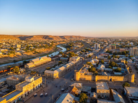 Aerial view of Asmara, Eritrea's capital city, showcasing its unique architecture and urban landscape at sunset.