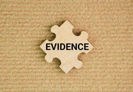 Wooden puzzle with the word evidence. any factual information, object, sign, or testimony that supports a claim, proves a point, or makes a truth apparent