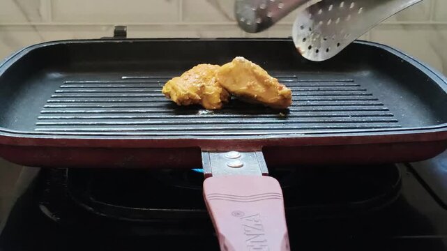 Footage of chicken being grilled on a teflon pan with delicious homemade cooking atmosphere.
Keywords: