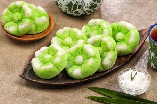 Putu Ayu, a traditional Indonesian steamed cake made with pandan flavor and topped with freshly grated coconut.
