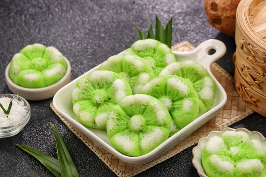 Putu Ayu, a traditional Indonesian steamed cake made with pandan flavor and topped with freshly grated coconut.