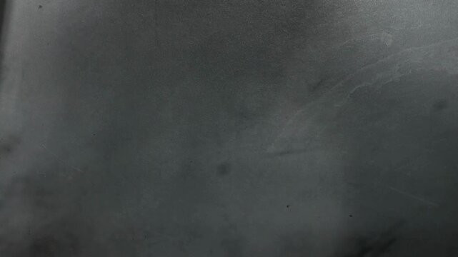 Dark grey surface with subtle signs of wear, ideal for backgrounds, texture overlays, and design projects needing a distressed look.