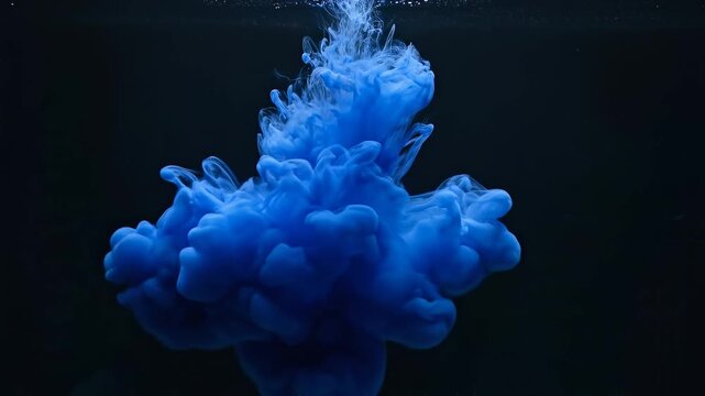 Vibrant blue ink cloud dissolving in water.