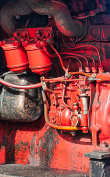 Closeup View of a Vintage Red Tractor Engine and Fuel Injection Pump industrial