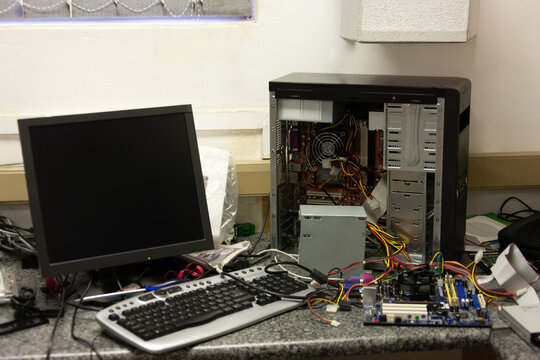 Disassembled Desktop Computer on Technical Service Workbench internal components during maintenance.