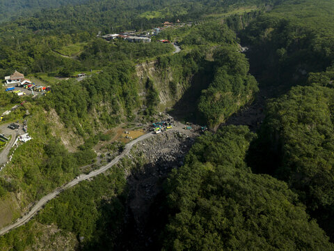 Aerial view of Tambang Pasir Merapi Kali Gendol Sand Mine with heavy machinery in the valley in Kecamatan Cangkringan, Daerah Istimewa Yogyakarta, Indonesia.